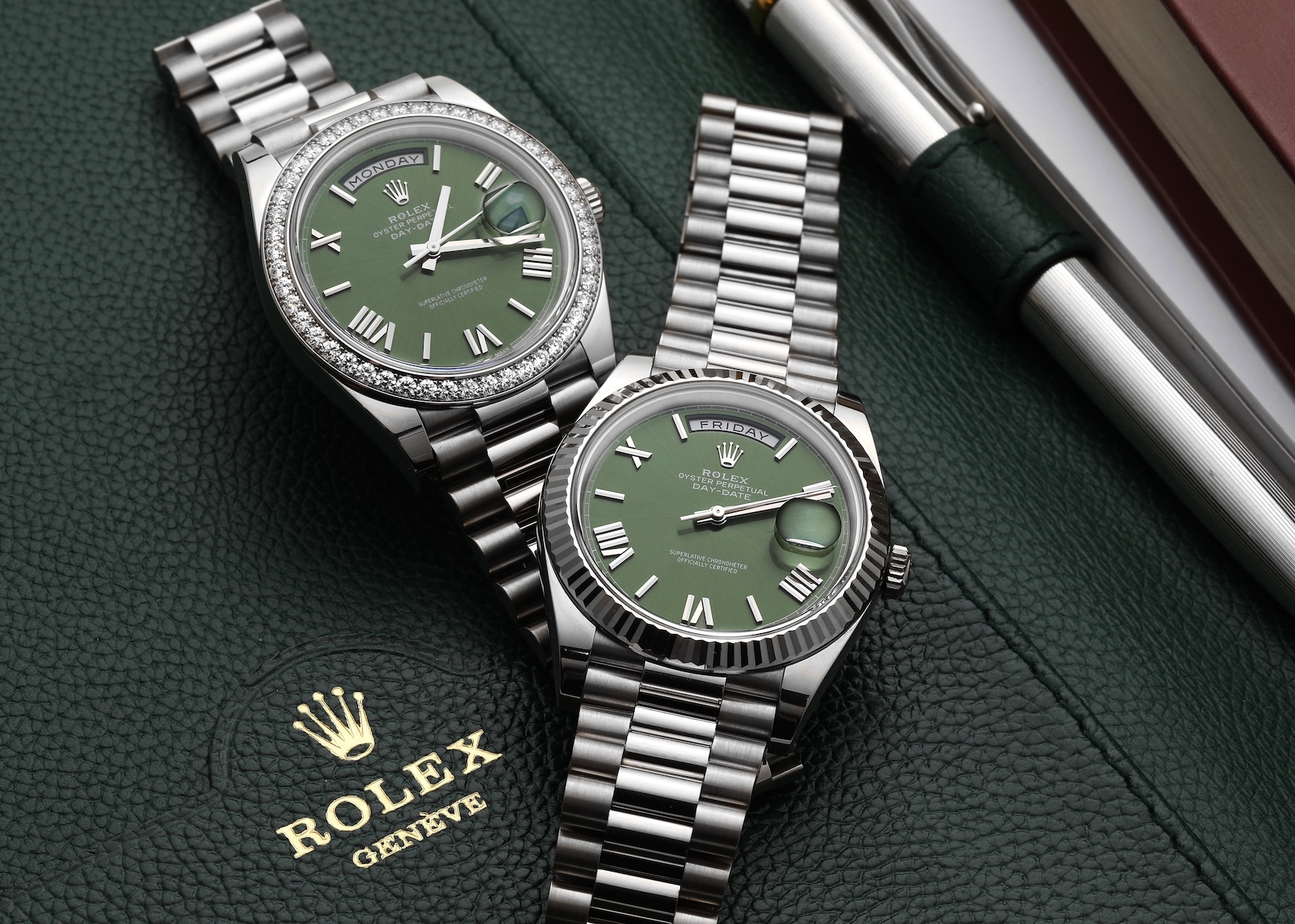 Two Rolex Day-Date watches featuring highly desirable green dials, one with a fluted bezel and one with a diamond-set bezel.