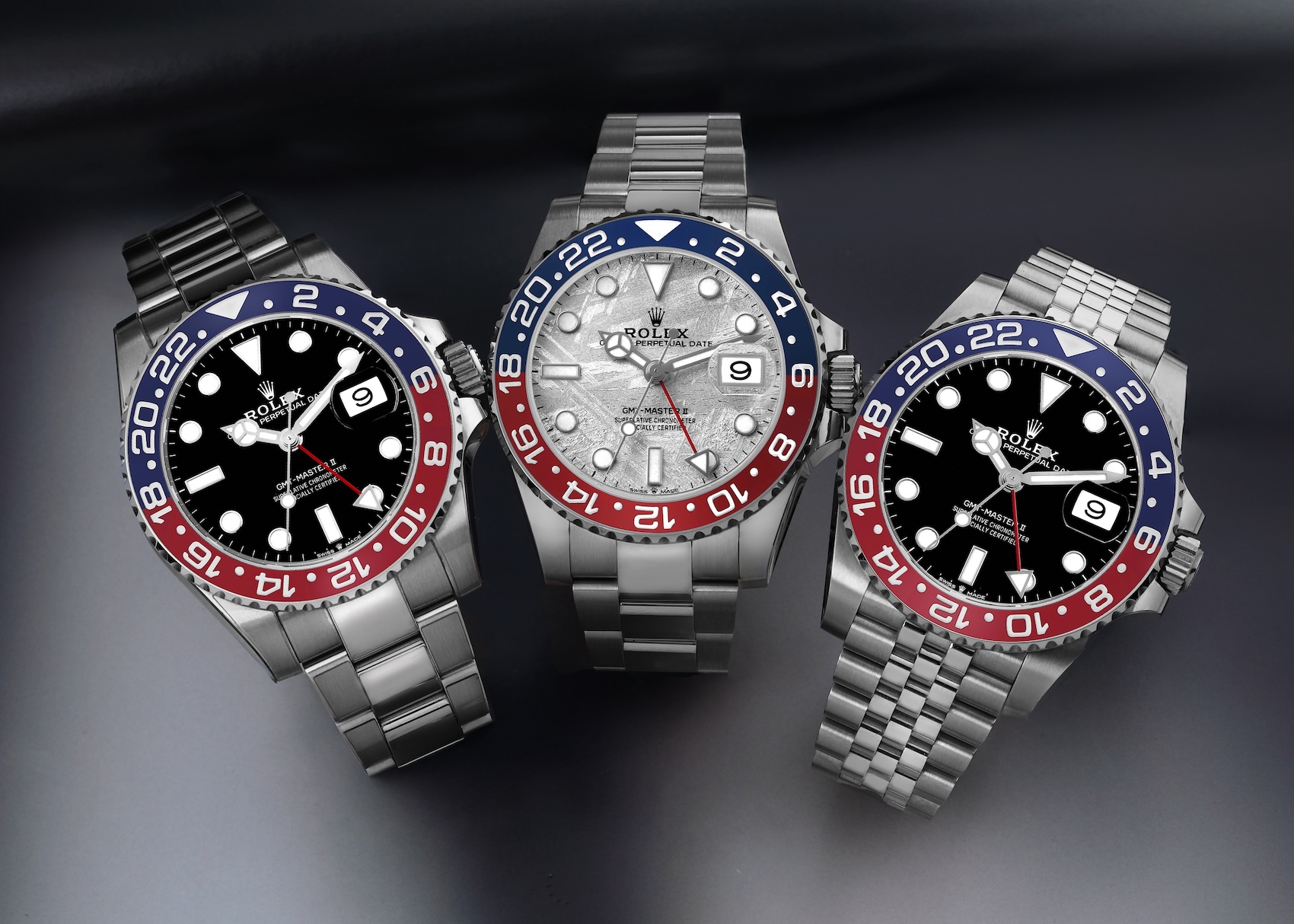 Three Rolex GMT-Master II watches with red and blue Pepsi bezels, highlighting the rare 126719BLRO white gold meteorite dial variation.