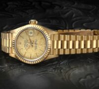 Vintage 26mm Rolex Ladies President Datejust reference 69178 in solid 18k yellow gold featuring a fluted bezel and textured champagne linen dial.