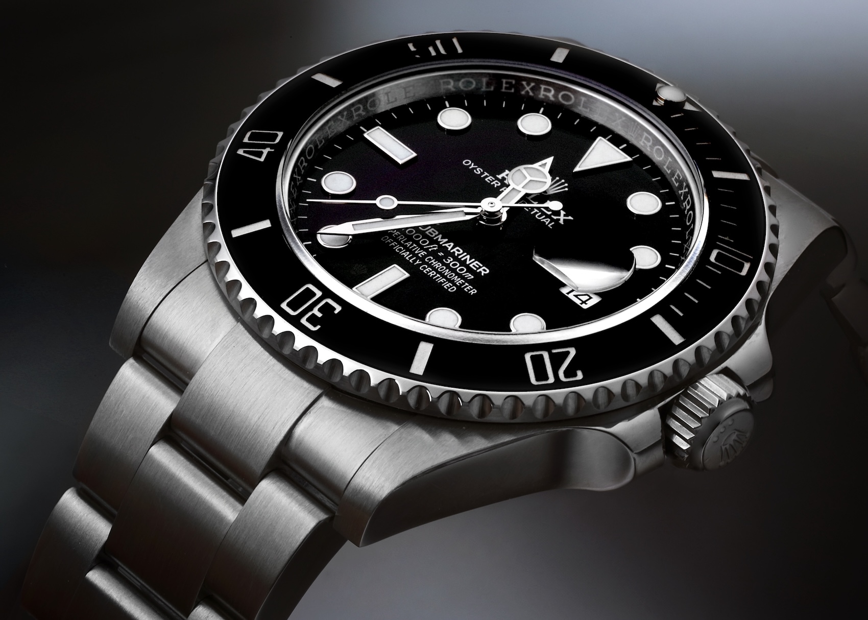 Macro photography of a Rolex Submariner Date focusing on the black dial, luminescent indices, Mercedes hands, and ceramic bezel.