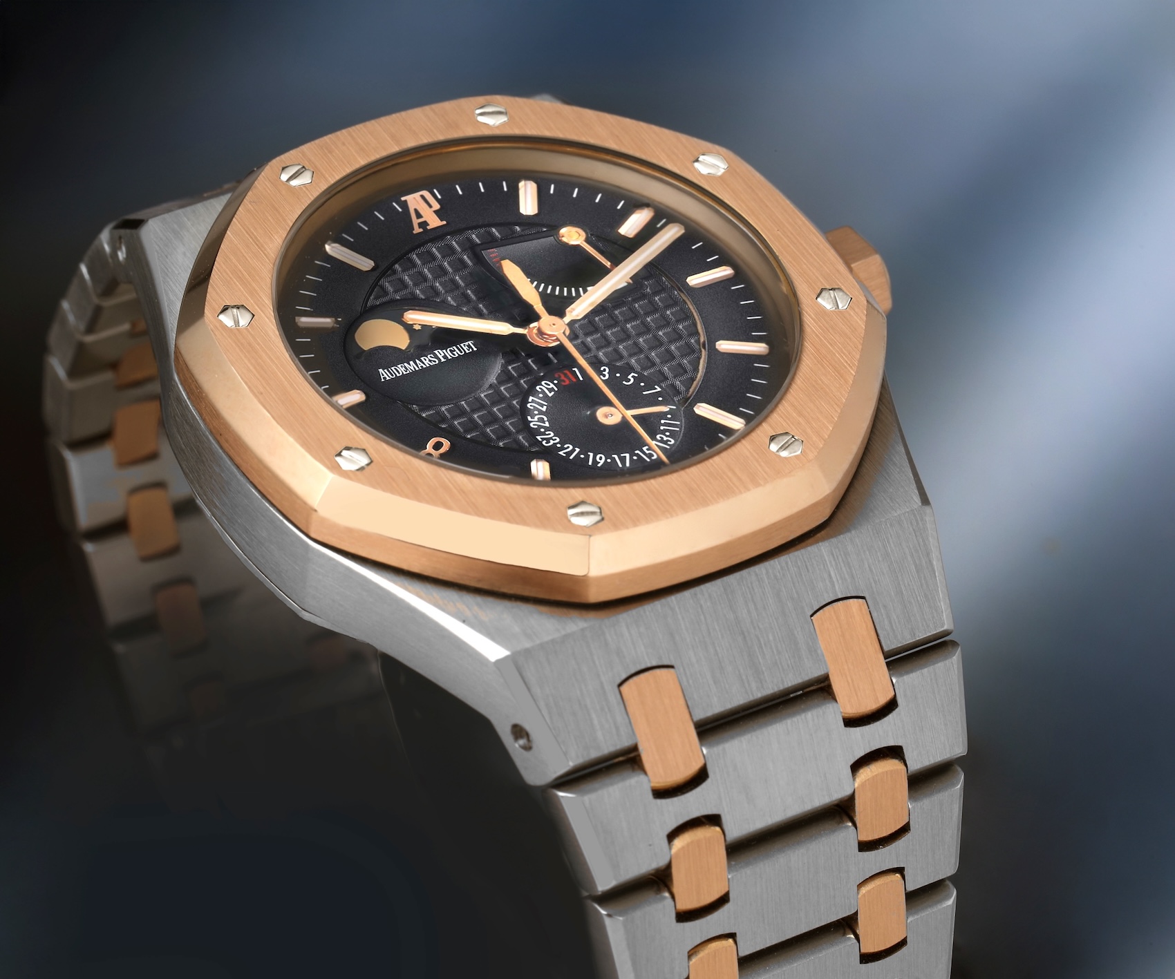 Audemars Piguet Royal Oak Pride of China Limited Edition stainless steel and 18k rose gold mens watch 26168SR with a black Grande Tapisserie dial, moonphase, power reserve, and pointer date.