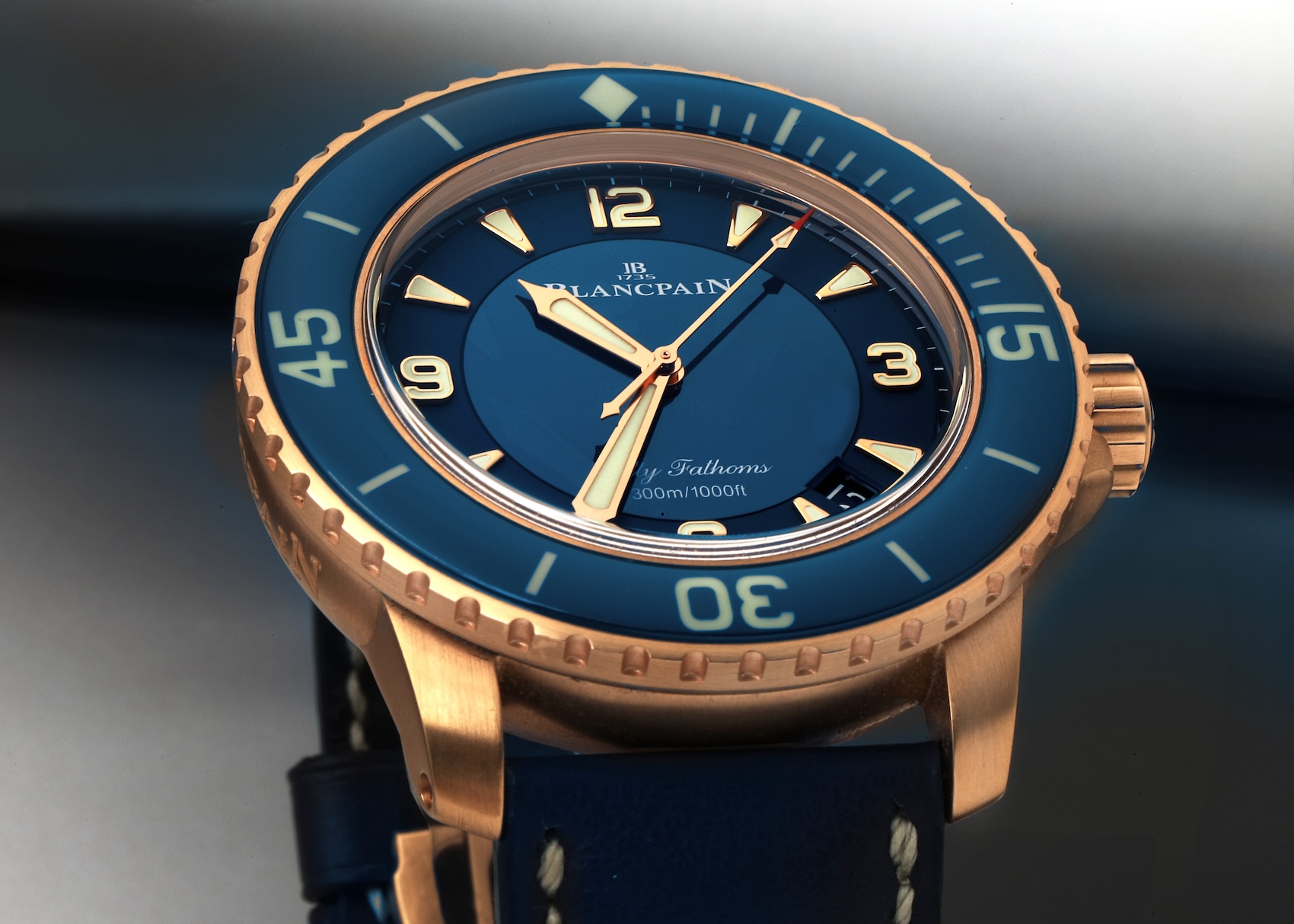 Blancpain Fifty Fathoms Automatique 5015 in rose gold featuring a blue dial and curved sapphire bezel.