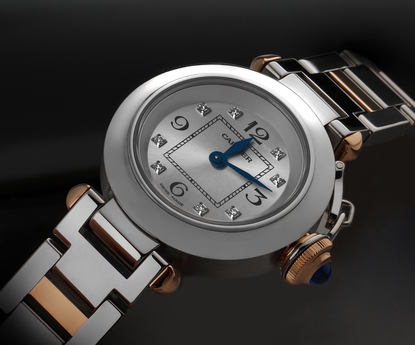 A two-tone steel and rose gold Cartier Miss Pasha watch with a diamond dial and the signature canteen crown.