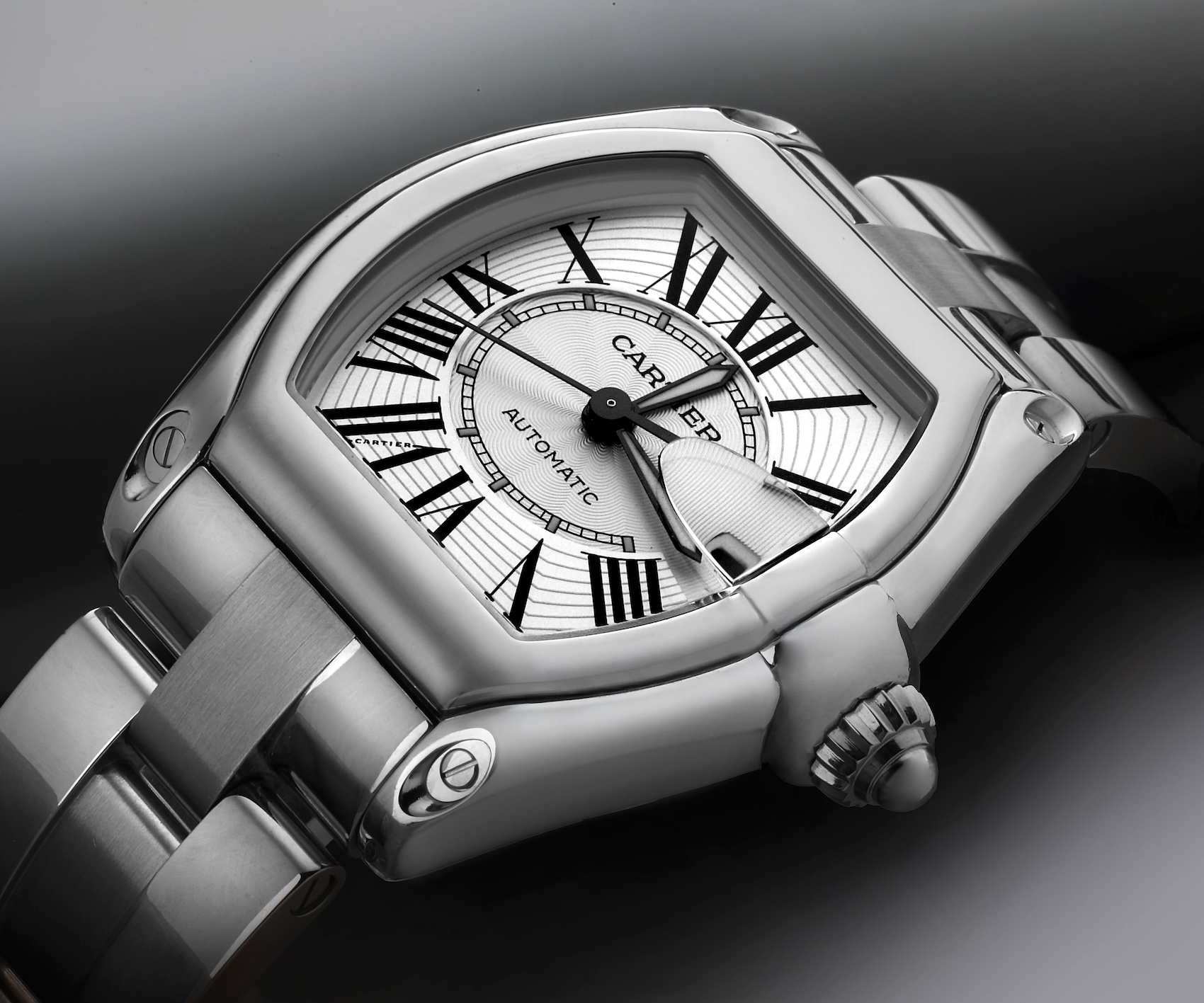 A stainless steel Cartier Roadster watch featuring a tonneau-shaped case, elongated date magnifier, and racing-inspired design.