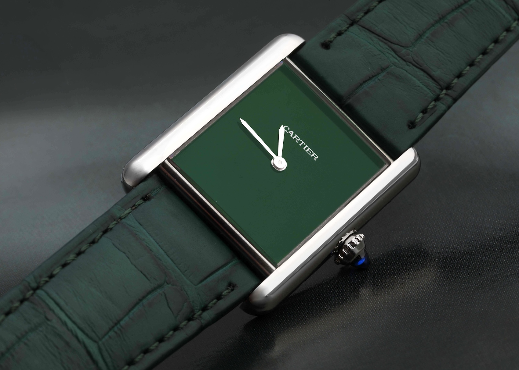 A Cartier Tank Must large model with a green dial and matching green leather strap, an entry-level Cartier watch under 5000 dollars.