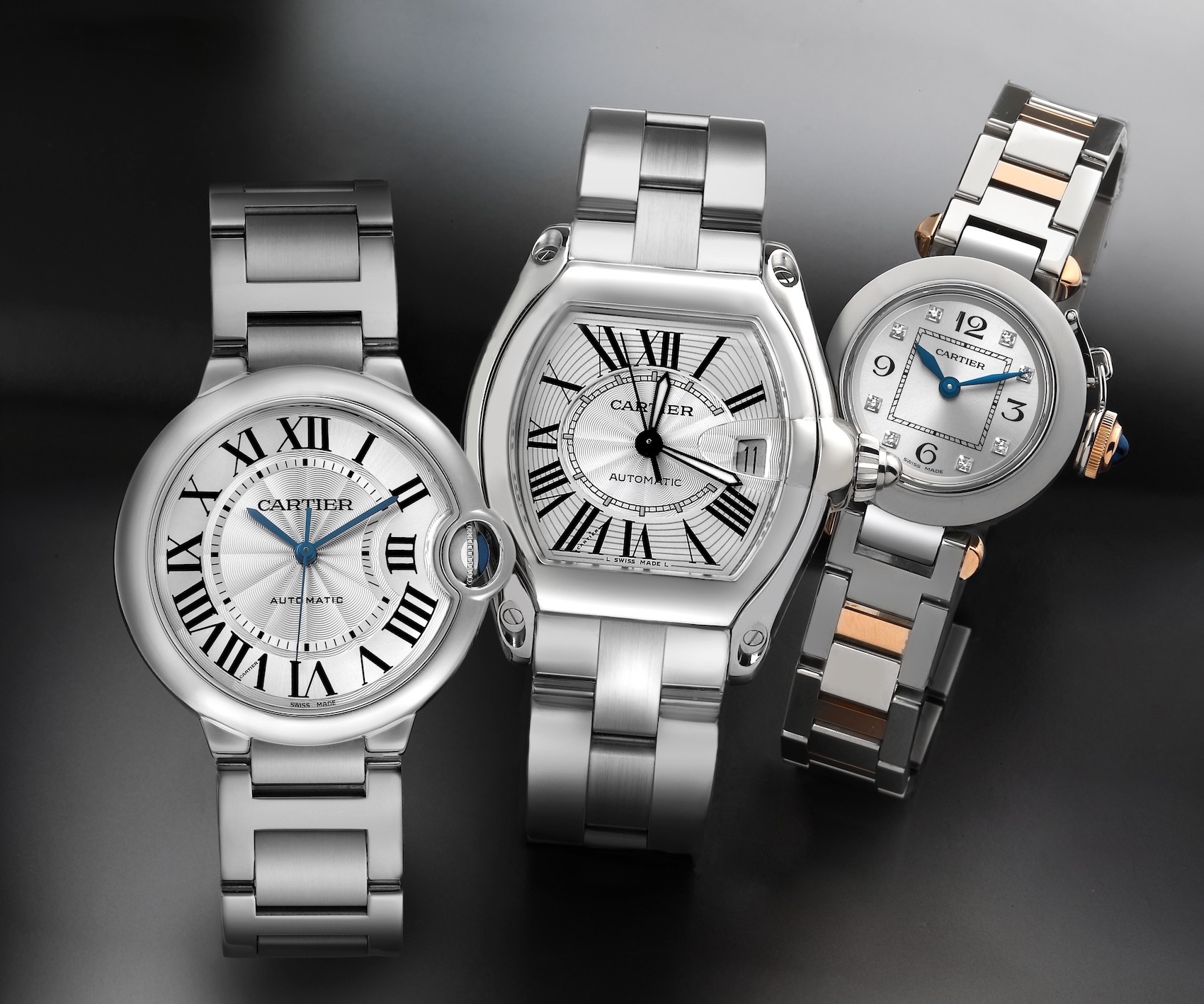 A collection of affordable Cartier watches under 5000 dollars, featuring a stainless steel Ballon Bleu, a tonneau-shaped Roadster, and a two-tone Miss Pasha watch.