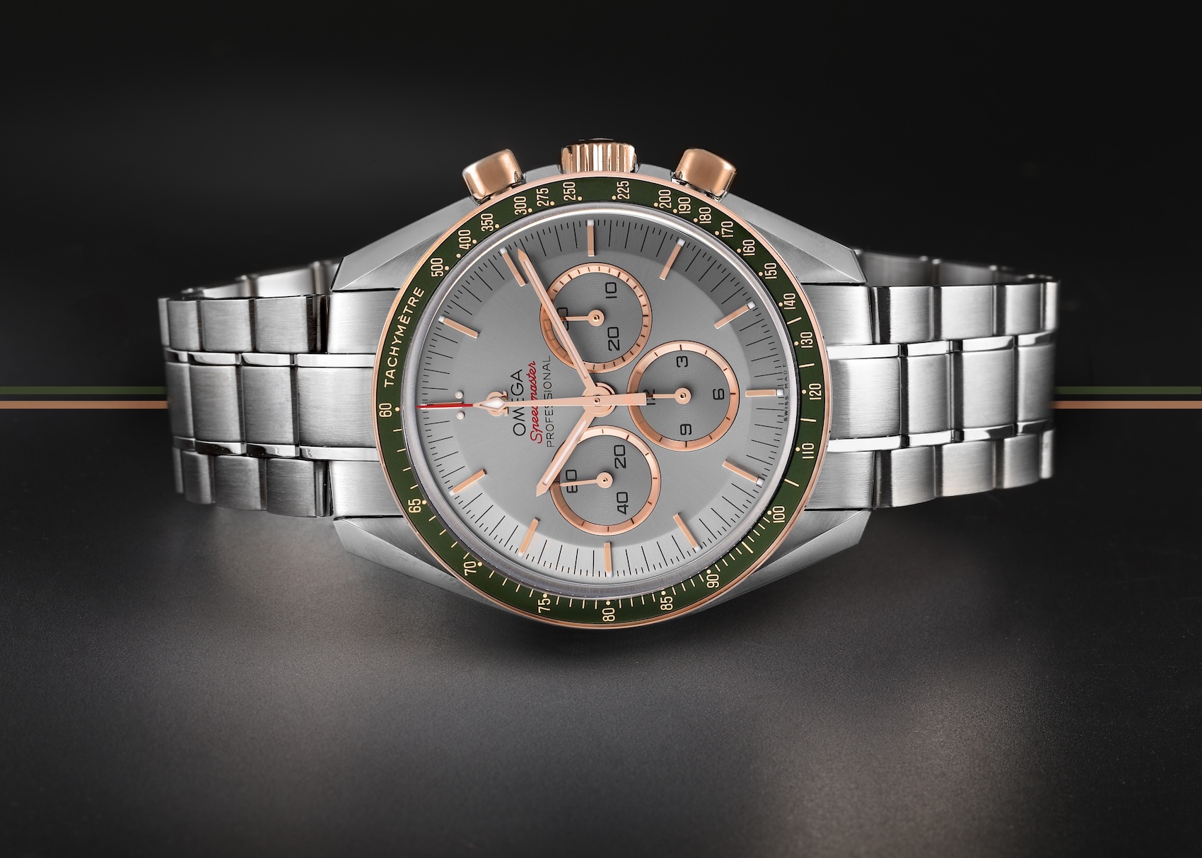 Omega Speedmaster Professional Tokyo 2020 Olympics Limited Edition 42mm stainless steel and 18k Sedna rose gold chronograph watch 522.20.42.30.06.002 with a green tachymeter bezel and grey dial.