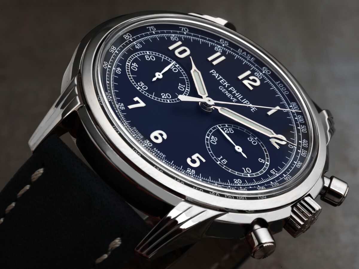 Angled close-up of the Patek Philippe Complications Chronograph 5172G-001 in white gold featuring a varnished blue dial, luminescent syringe hands, and navy calfskin strap.