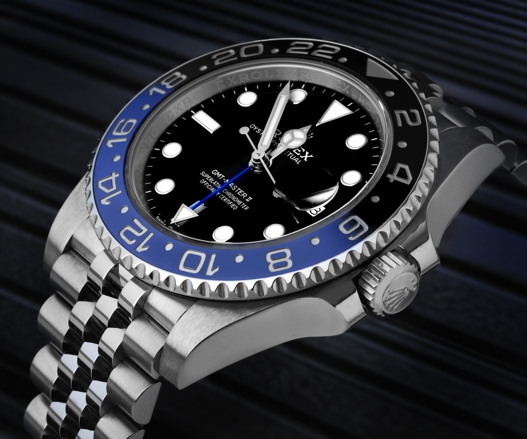 Close-up macro shot of the Rolex GMT-Master II Batgirl reference 126710BLNR showing the black and blue Cerachrom ceramic bezel and Jubilee bracelet.