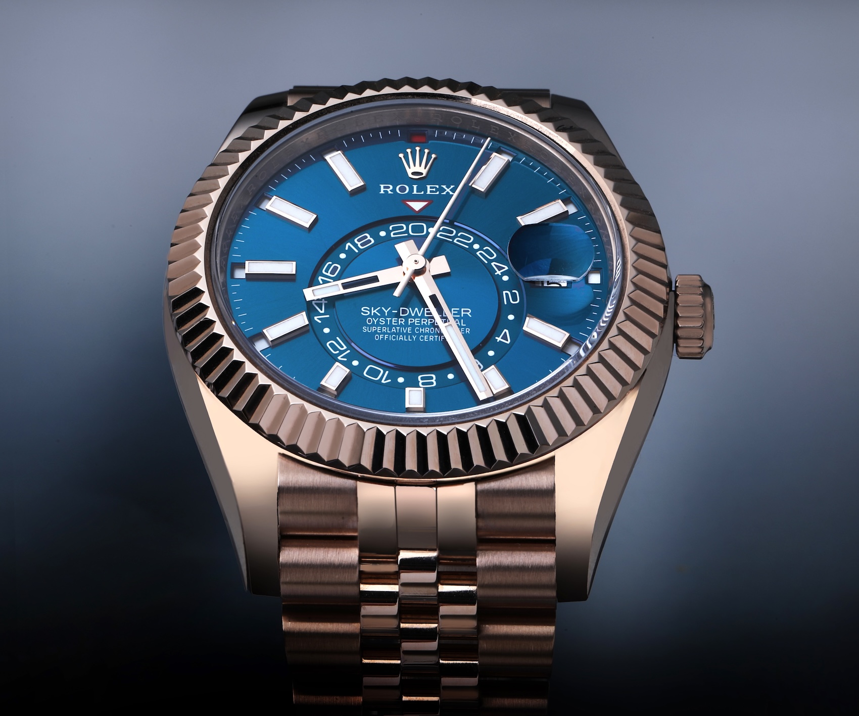 Front view of the Rolex Sky-Dweller reference 336935 in full 18k Everose gold with a blue-green dial and Oyster bracelet.