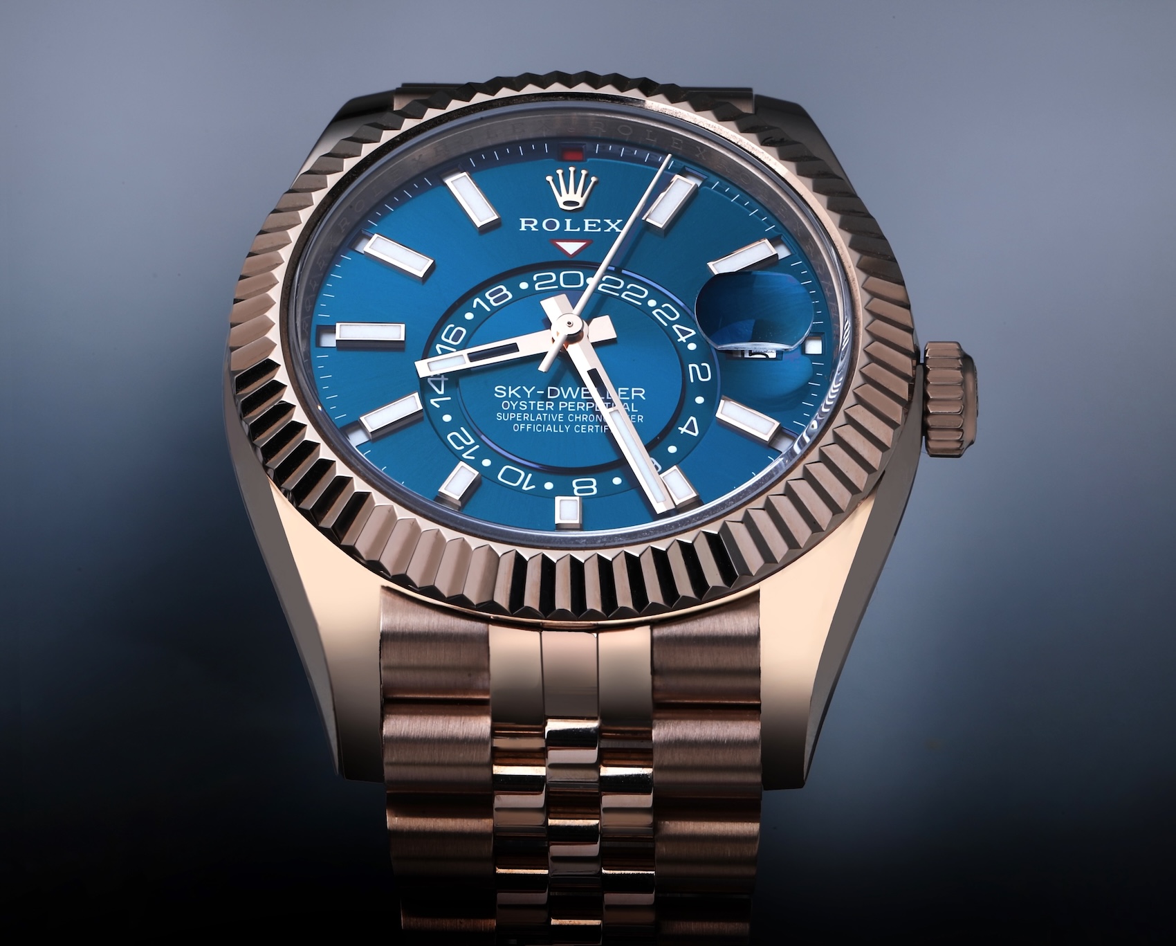 Rolex Sky-Dweller Ref. 336935 in 18k Everose gold featuring a blue-green dial and solid rose gold Jubilee bracelet.